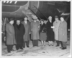 Photograph of Rabbi Silver with other individuals in front of an airplane