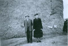 Photo Couple in Front of Pile of Hay 