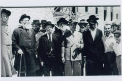 Rabbi Elizer Silver Outdoors in Israel Surrounded by a Group of Unidentified Men